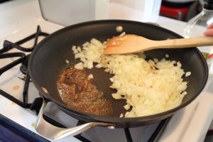 Here is how I carve out a spot for heating up spices before mixing them into fried onions. Heating the spices helps make them taste better.