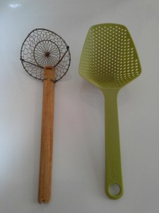 Use scoopy things like this, or thongs, a sieve or anything else that will accomplish the same goal of veggies out of hot water.