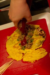 Take the paratha/egg off the heat and add the filling. (There is a litte too much egg on this one)