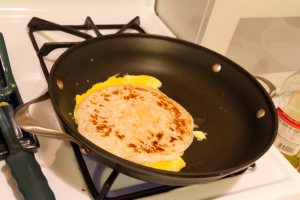 Put the cooked paratha on the egg as it cooks