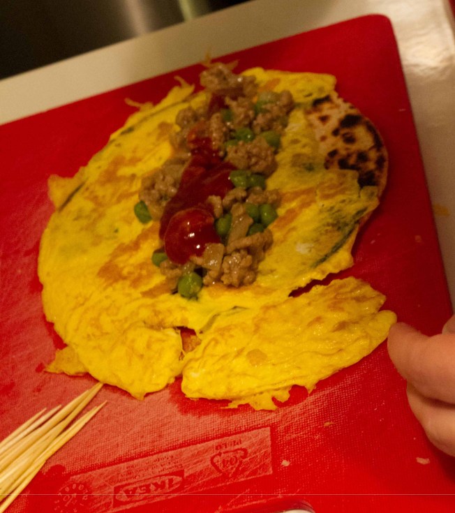 Egg roll before it is rolled - parathas, egg, keema and sauce, yum!