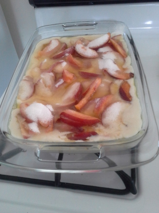 Before going in the oven. The butter and the batter don't mix. Then add the peaches and top with sugar. I forgot to take a picture when it came out of the oven.