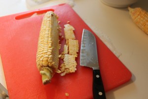 Get a firm hold of the cob and cut off the kernels