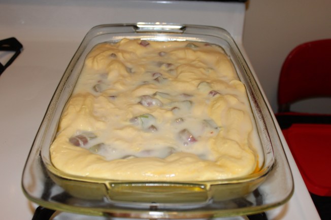 The rhubarb mixture will fall through the cake batter as it cooks. Just try to make sure the rhubarb spread out throughout the pan