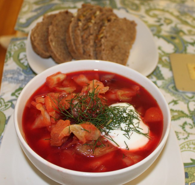 Borscht with sour cream and dill served with hearty bread